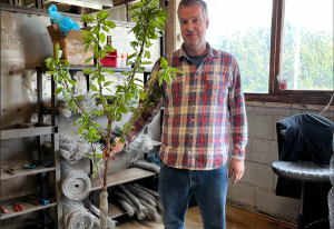 the morten holds a tree with a trunk protector